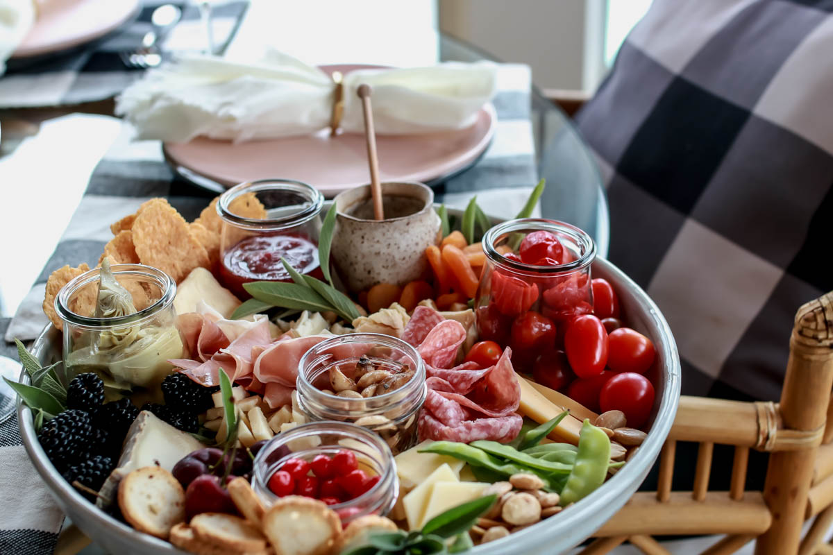 Create an array of meats, cheese, fruits and spreads 