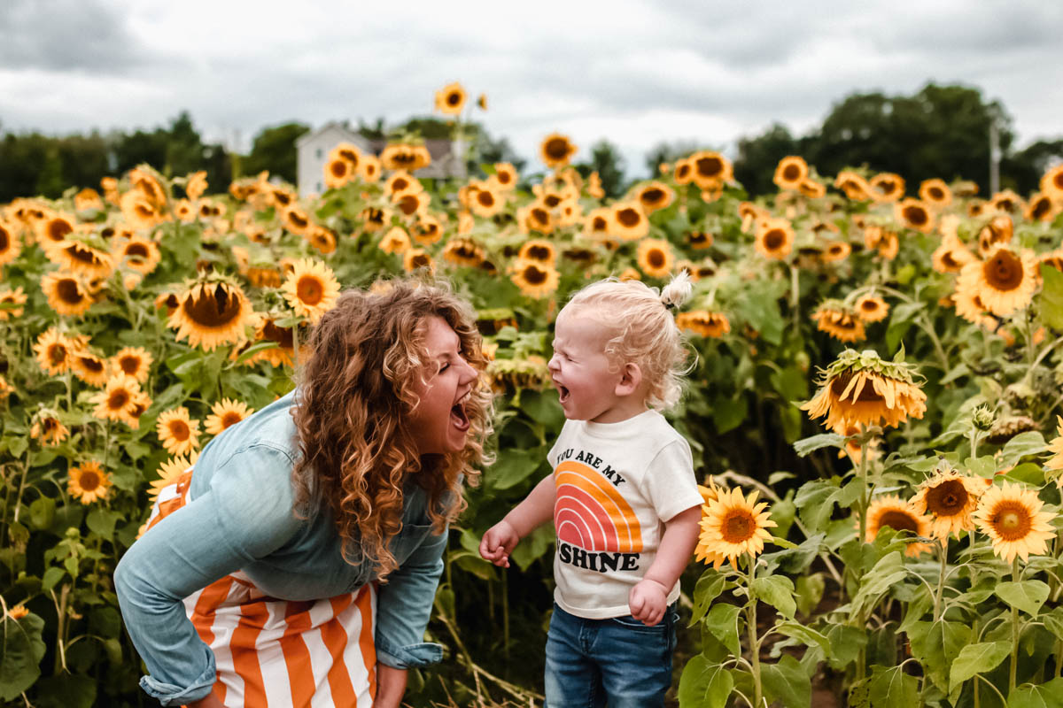 Large Sunflower field with boden striped skirt toddler photo shoot in massive sunflower 