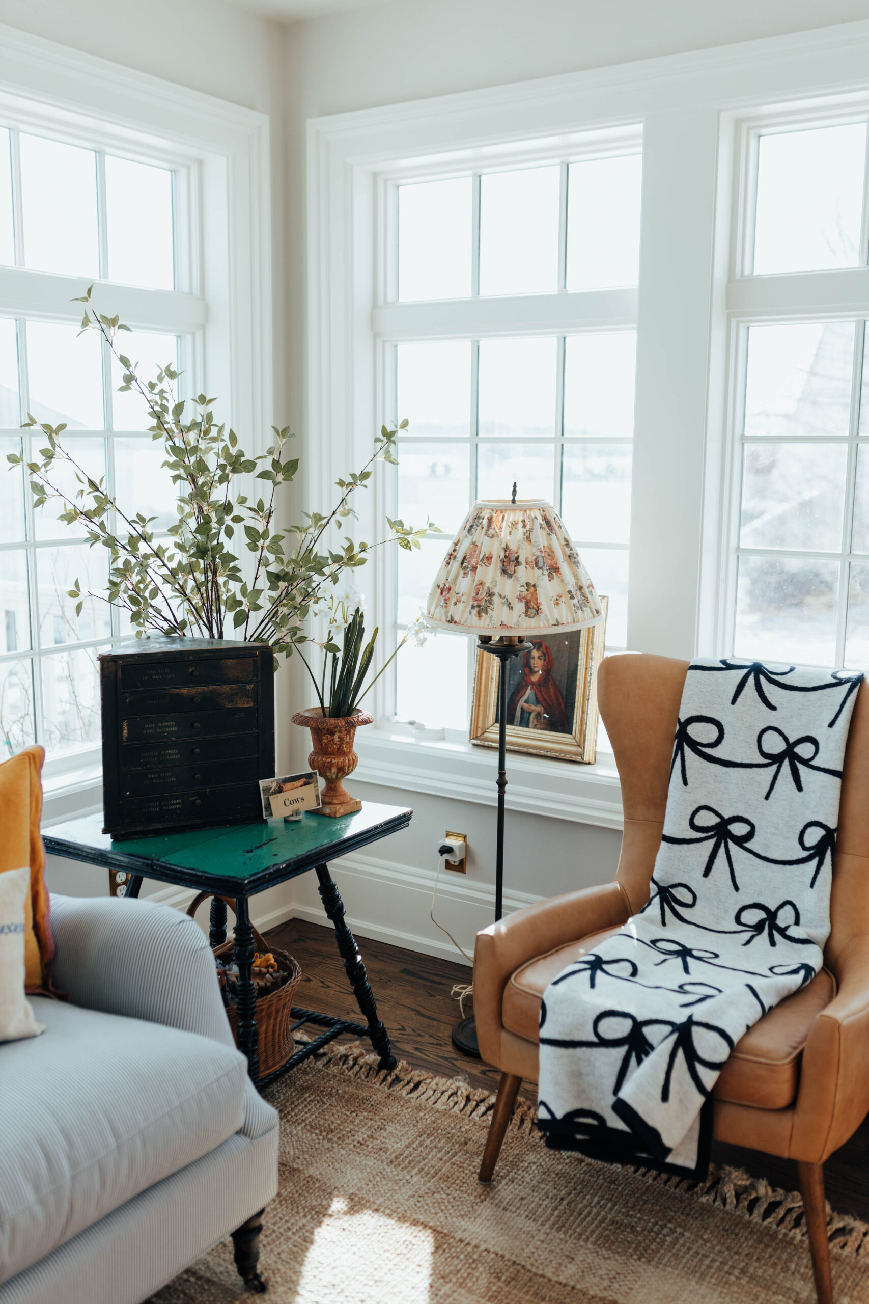 Chappy Wrap Bow Blanket on a leather brown west elm chair